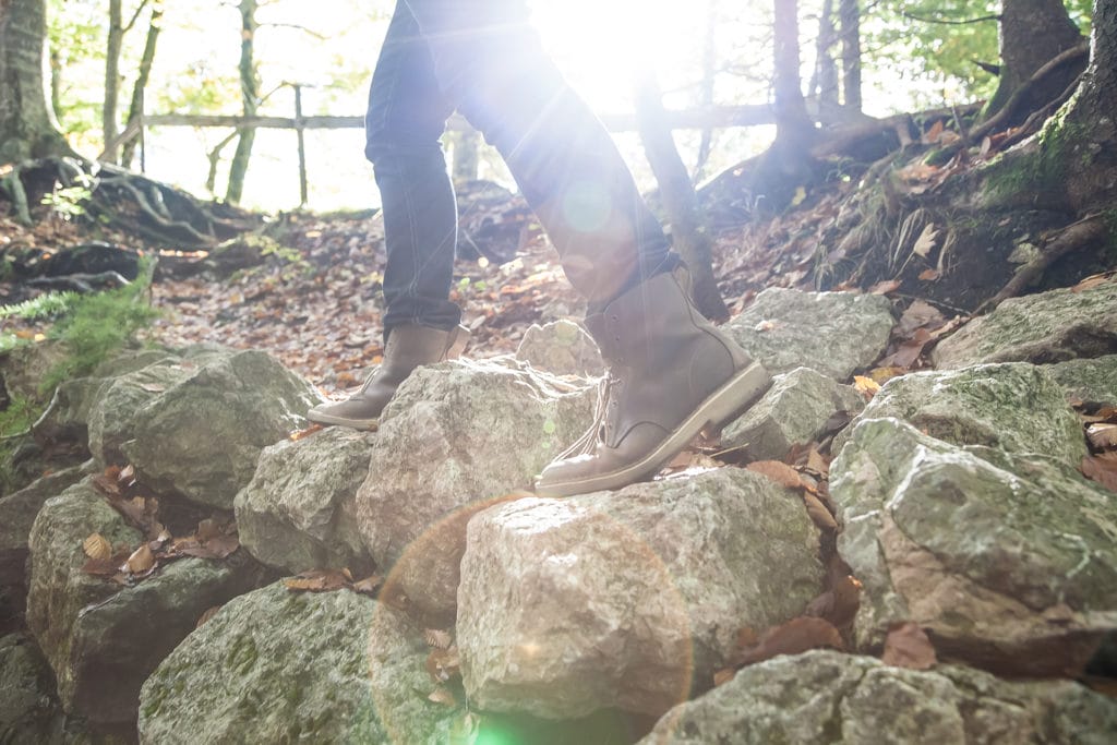 Stephen's legs and hiking boots as he hikes in the mountains in Germany. Knowing what to pack is essential for travel planning.