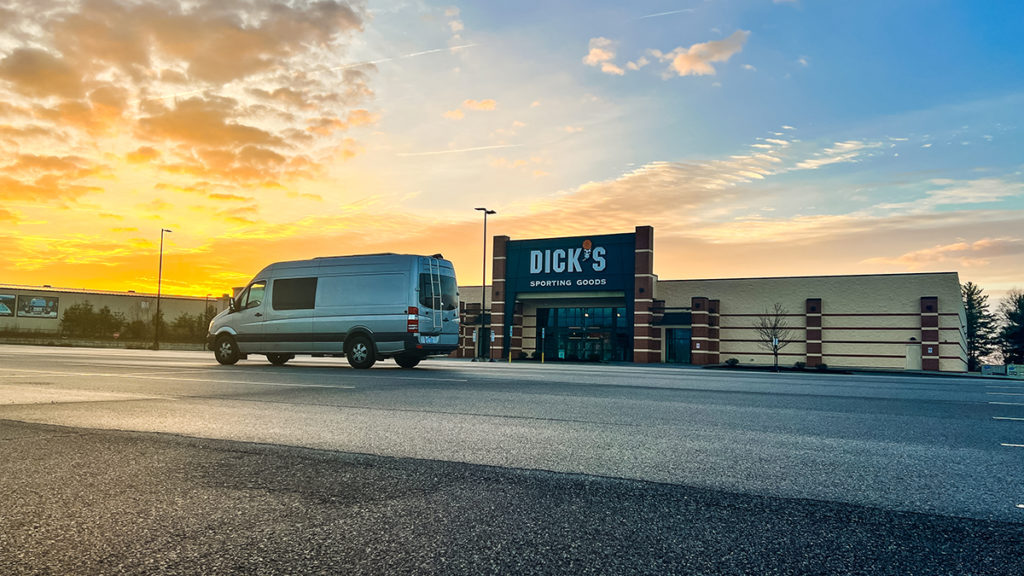 Sprinter campervan parked in Dick's Sporting Goods parking lot.